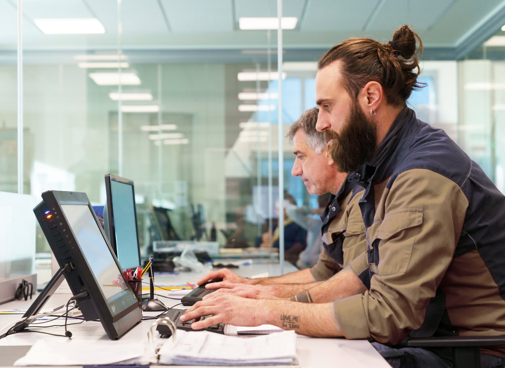 Two technicians at computer workstations in the Eredi Baitelli technical office